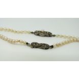 Two pearl necklaces with silver clasps