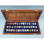 A cased set of 42 hallmarked silver and enamel Danbury Mint Heraldic Emblems of the Kings and