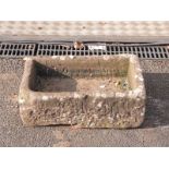 A small carved natural stone trough,