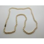 A single strand of cultured pearls with 9ct gold clasp set with a diamond and sapphire