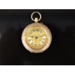 A 14k yellow metal cased ladies fob watch with keyless wind movement and engraved foliate