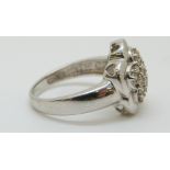 A 14ct white gold ring set with diamonds in a cluster,