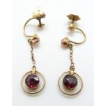 A pair of 9ct gold earrings set with garnets