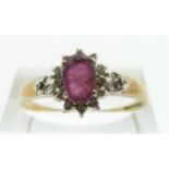 A 9ct gold ring set with a ruby and diamonds, size T, 1.