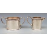 A Victorian hallmarked silver sugar bowl and milk jug of cylindrical form with beaded edge,
