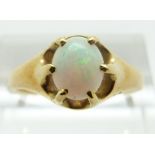 A yellow metal ring set with an oval opal cabochon, size P, 4.