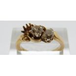 An 18ct gold ring set with two old cut diamonds, the largest approximately 0.35ct, size O, 5.