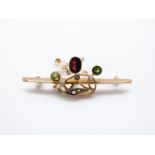 A 9ct gold brooch set with seed pearls, peridot and an oval garnet, 2.