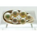 A 9ct gold ring set with pearls, size R, 3.