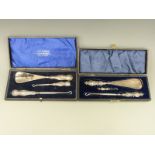 A cased hallmarked silver handled button hook / shoe horn set and another set with Art Nouveau