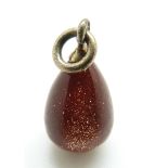 A Russian sunstone egg pendant with silver loop marked 84,