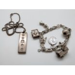 A silver charm bracelet and silver ingot