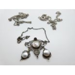 A silver necklace set with three mother-of-pearl cabochons and two chains