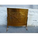An embossed copper fire screen