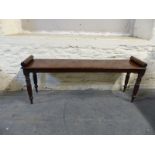 A 19thC mahogany window seat with octagonal legs,