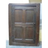 An antique oak housekeeper's cupboard with peg jointed panelled door,