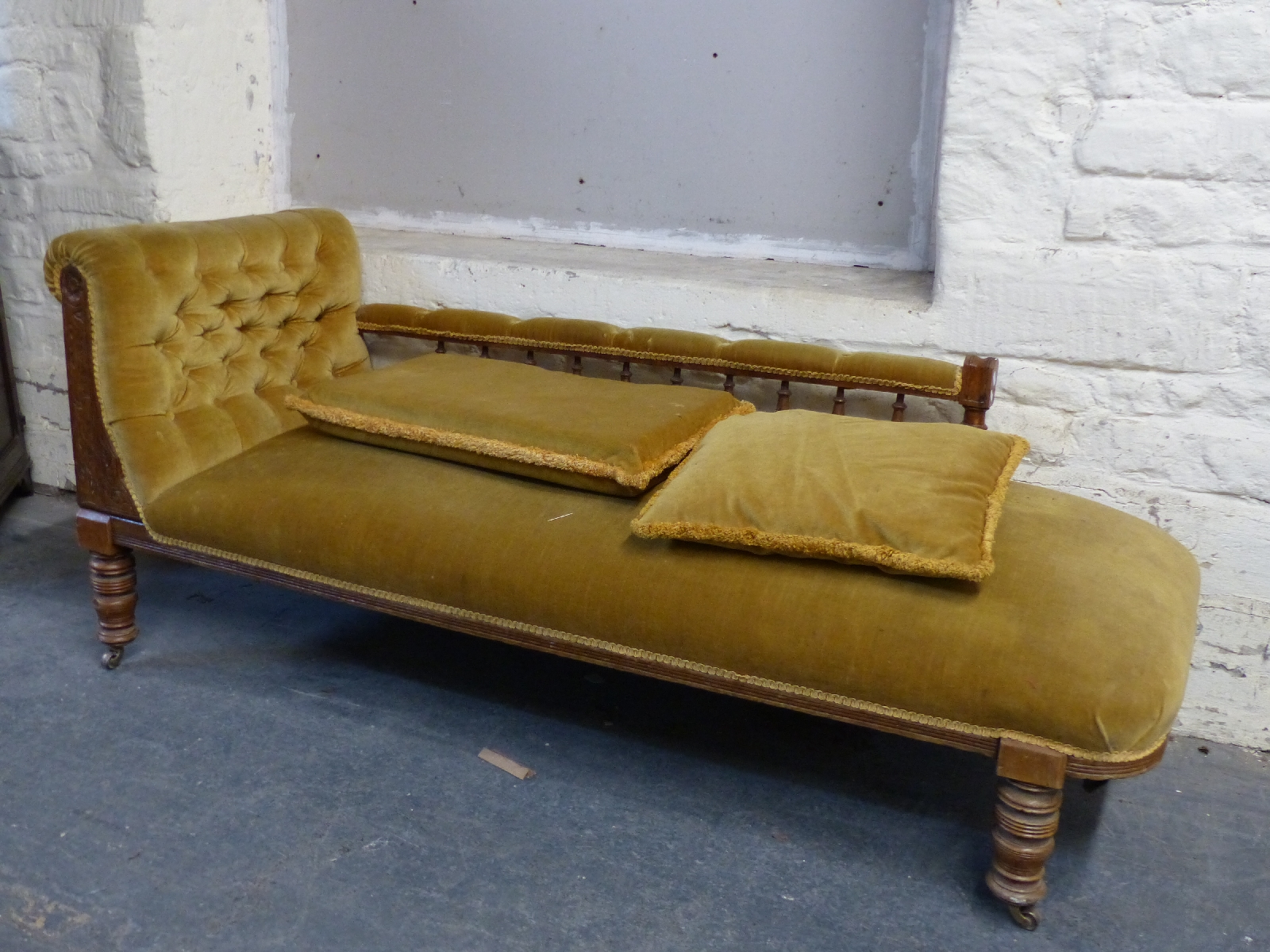 A 19thC upholstered chaise longue with turned supports to rear and turned legs