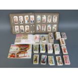 A collection of c1930's - 1960's cigarette and tea cards, some in albums and some loose,