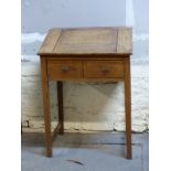 A 19thC oak clerk's desk with lift up flap and two drawers below,