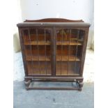 An oak glazed display cabinet,