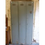 A triple metal locker unit stamped Welconstruct,