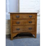 An oak chest of three drawers with Art Nouveau style handles,