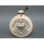 A stoneware small hot water bottle marked Sussex Stores,