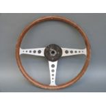 A vintage wood rimmed aluminium steering wheel,