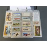 A collector's folder containing a large collection of cigarette cards,