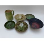 Six pieces of studio pottery including five bowls / dishes and a jug,