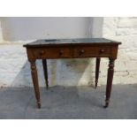 A 19thC two drawer mahogany desk in the manner of Gillows with reeded legs terminating in brass