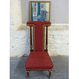 A Victorian upholstered Prie Dieu chair with gilt decoration and a painting of the chair