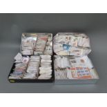 A large quantity of loose GB and Canada stamps in packets and tins