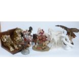 A collection of ceramic and resin figures including eagles, horses, leopard book ends,