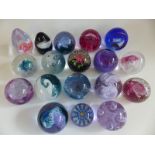 Seventeen Caithness Glass paperweights comprising Tidal Wave, Flower in the Rain, HM Queen Mother,