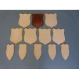 Twelve wooden taxidermy shield shaped mounts in two sizes, 33x26 and 30x15cm.