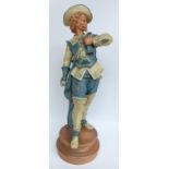 A large 19th/20thC pottery figure of a Cavalier on a terracotta base in Goldscheider style,