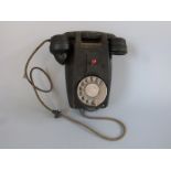 A vintage wall mounted telephone