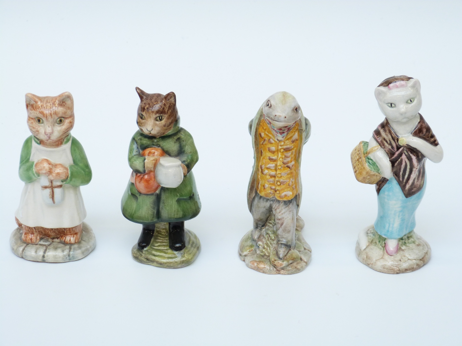 Four Beswick Beatrix Potter figures Susan, Ginger, Simpkin and Sir Isaac Newton,