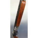 Remington model 1100 12 bore semi-automatic shotgun with ornately carved semi-pistol grip and