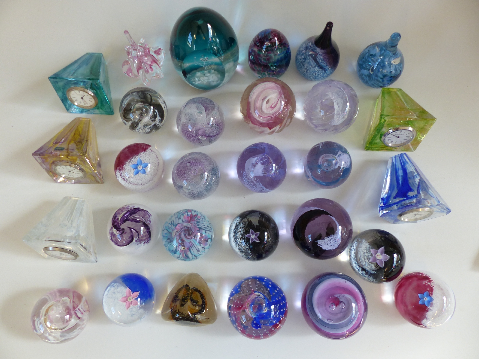 Twenty nine Caithness glass paperweights and paperweight clocks including Collectors' Society,