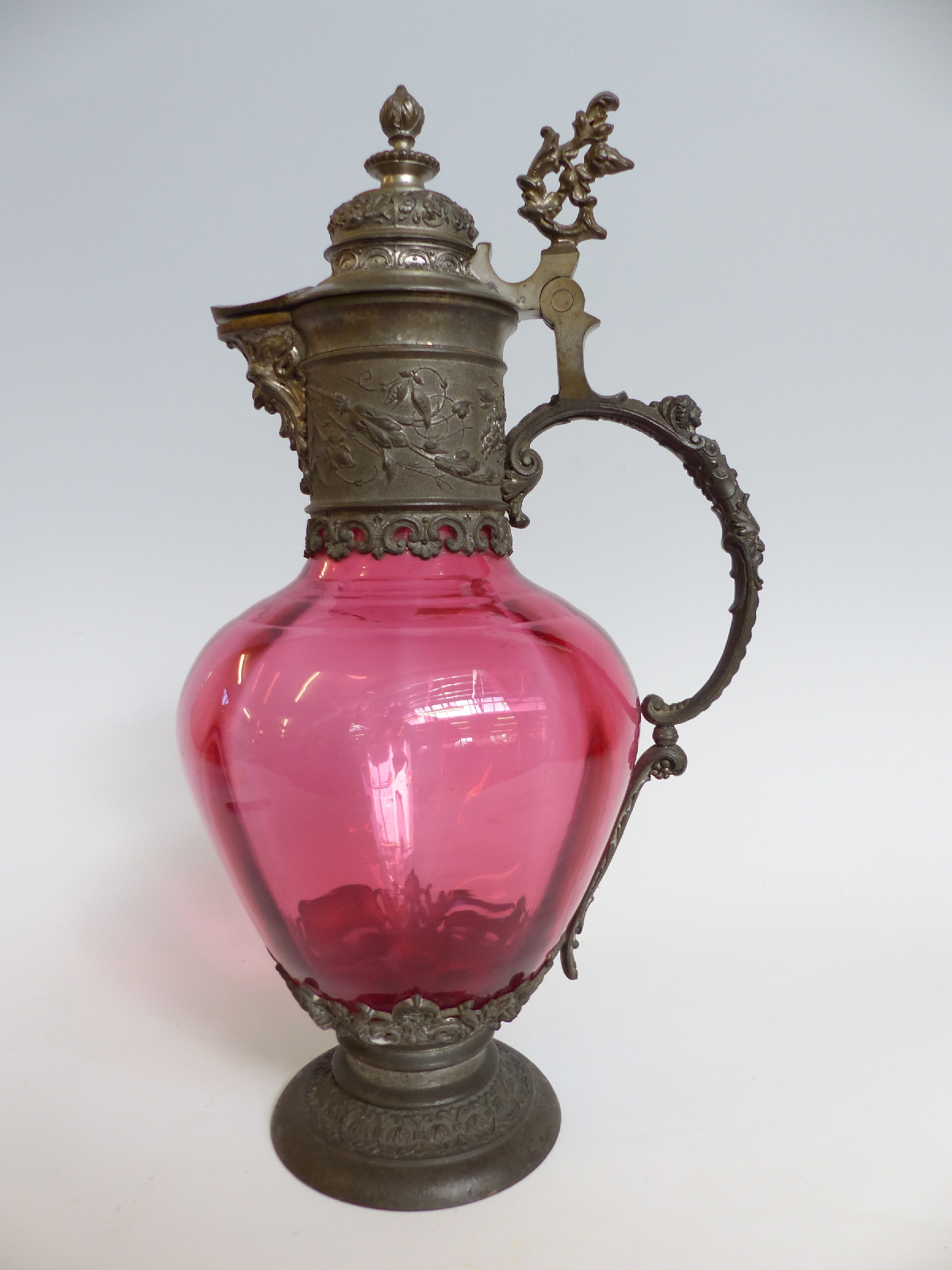 A pewter mounted cranberry glass claret jug,