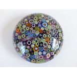 Clichy style close packed millefiori glass paperweight with various multi-coloured and pink,