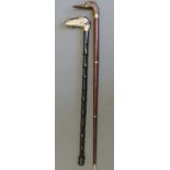 Two walking sticks, one carved and painted in the form of a ram,