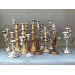 A collection of plated, brass and other candelabra,