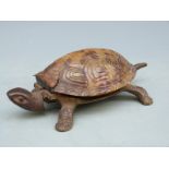 A vintage clockwork tortoise desk bell operated by pressing the head or tail, impressed GSS to base,