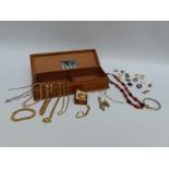 A collection of costume jewellery to include a camelian and garnet necklace, badges,