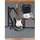 Encore electric lead guitar in black and ivory coloured finish together with a guitar stand,