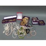 A collection of jewellery including pearl necklaces, peridot necklace, smoky quartz necklace,