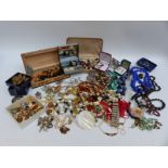 A collection of costume jewellery to include beads, lucite brooch and earrings,